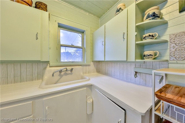 bathroom with a sink and wooden walls