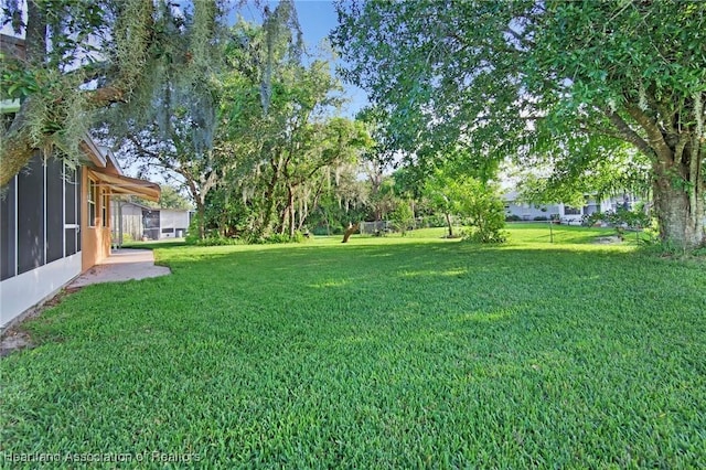 4311 Mandarin Rd, Sebring, FL 33875 - view of grassy yard with a sunroom