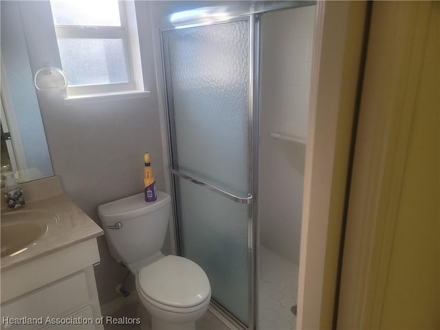 bathroom with vanity, an enclosed shower, and toilet