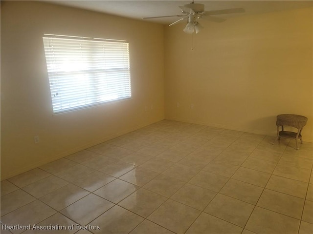 spare room featuring ceiling fan and light tile patterned floors