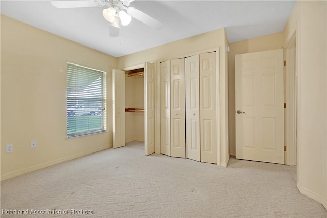 4311 Mandarin Rd, Sebring, FL 33875 - unfurnished bedroom featuring carpet, two closets, and a ceiling fan