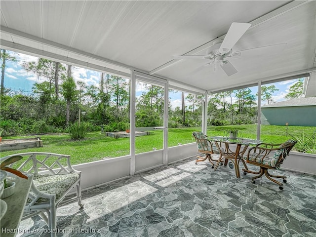 sunroom featuring ceiling fan