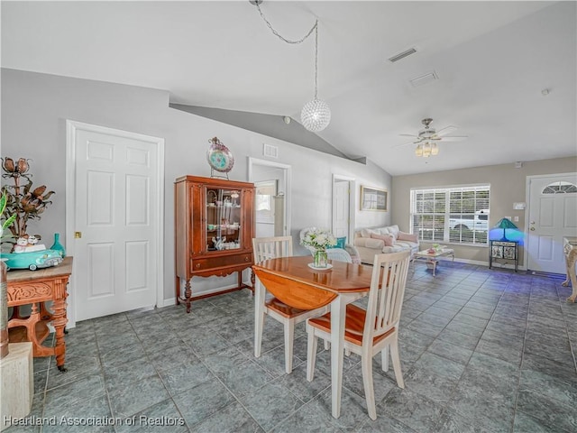 dining room featuring visible vents, lofted ceiling, baseboards, and a ceiling fan