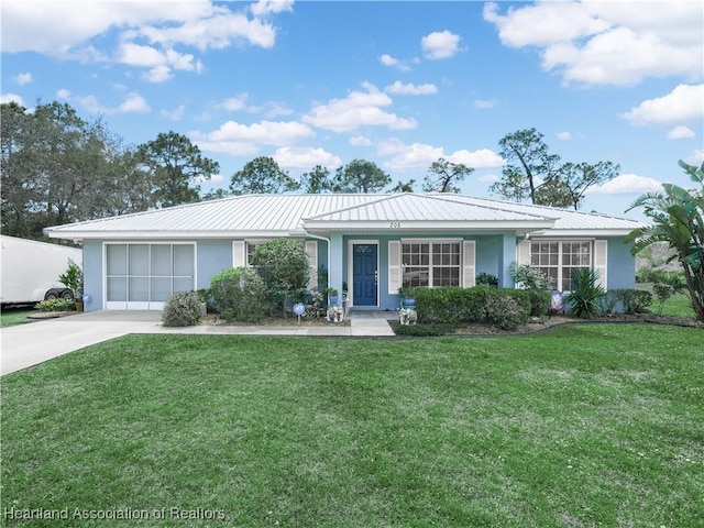 single story home with concrete driveway, a front yard, stucco siding, metal roof, and an attached garage