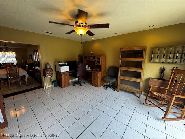 tiled office space with a textured ceiling and ceiling fan