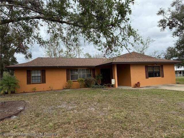 ranch-style home with a front lawn