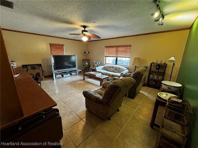 tiled living room with crown molding, ceiling fan, track lighting, and a textured ceiling