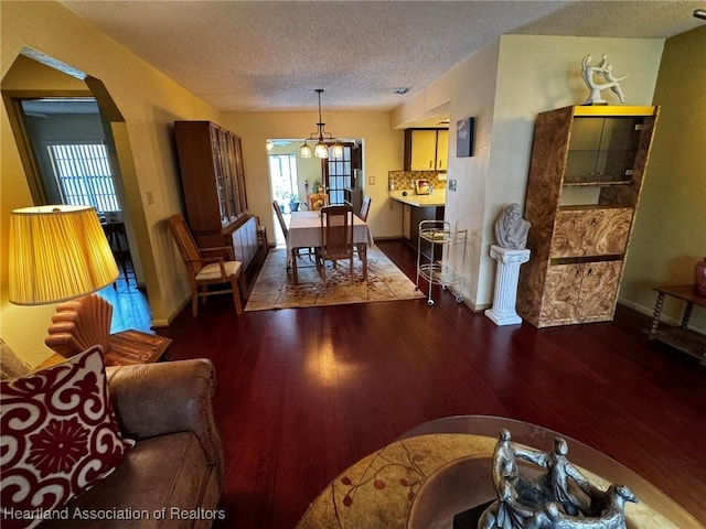 living room featuring dark hardwood / wood-style flooring and a textured ceiling