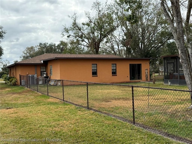 view of side of home with a lawn