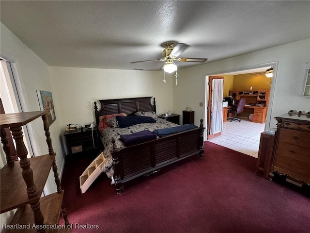 carpeted bedroom with ceiling fan and a textured ceiling