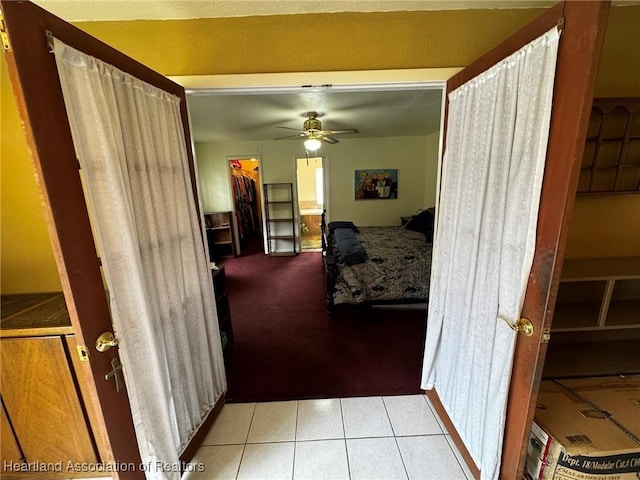 bedroom featuring a spacious closet, a closet, and light tile patterned floors