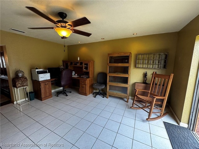 home office featuring light tile patterned floors and ceiling fan