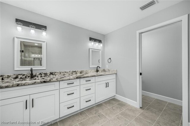 bathroom with vanity and tile patterned floors