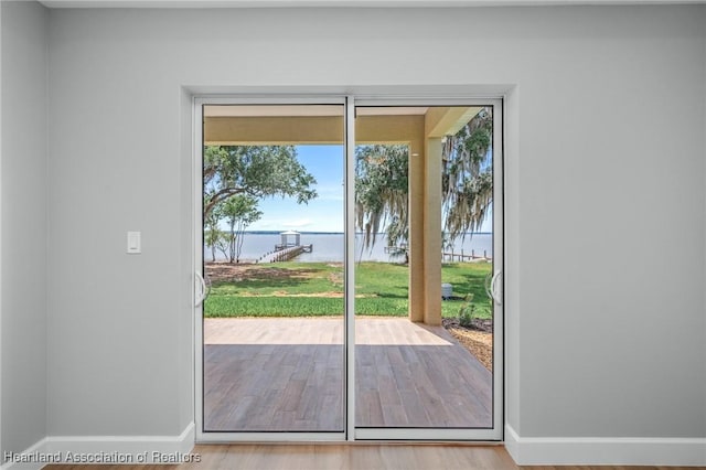 doorway featuring hardwood / wood-style floors and a water view