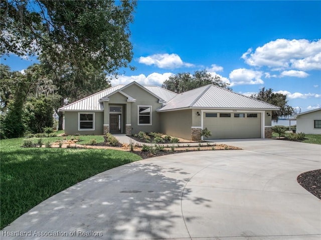 view of front of property featuring a garage and a front lawn