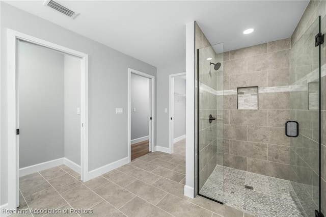 bathroom with tile patterned flooring and an enclosed shower