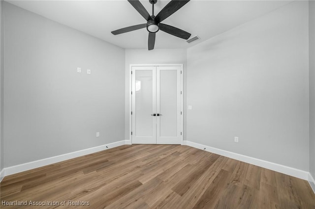 unfurnished room featuring ceiling fan and hardwood / wood-style flooring