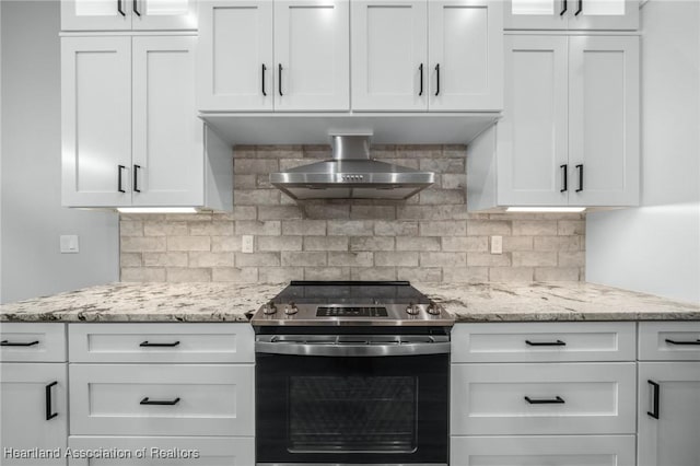 kitchen featuring white cabinets, wall chimney range hood, and stainless steel electric range oven