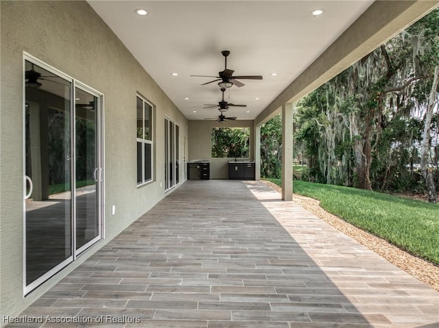 view of patio featuring an outdoor kitchen and ceiling fan