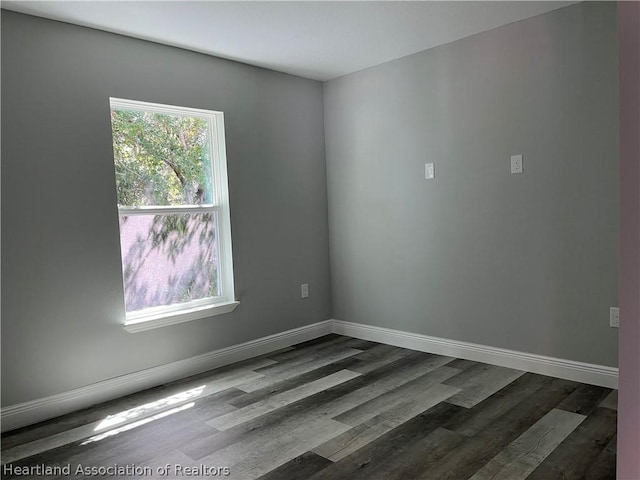 unfurnished room with hardwood / wood-style flooring