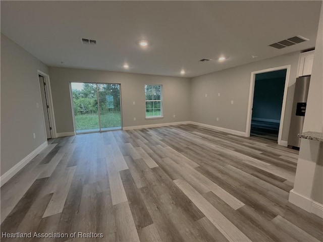 unfurnished living room with light hardwood / wood-style floors