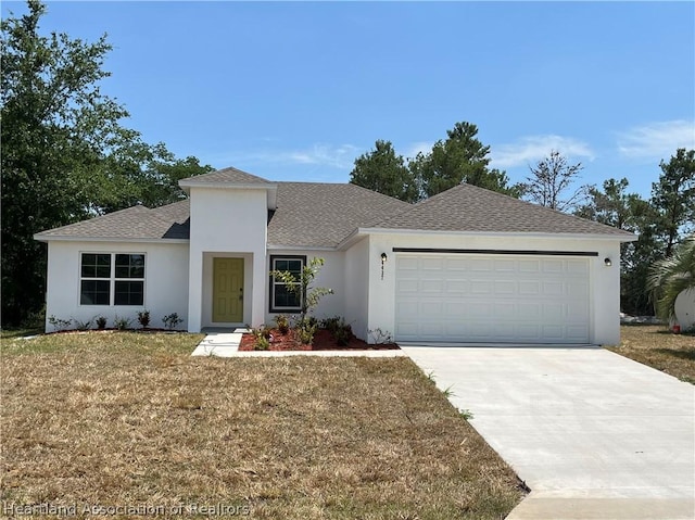 view of front of property with a front yard and a garage