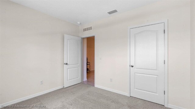 6824 Coconut Dr, Sebring, FL 33782 - unfurnished bedroom with carpet and baseboards