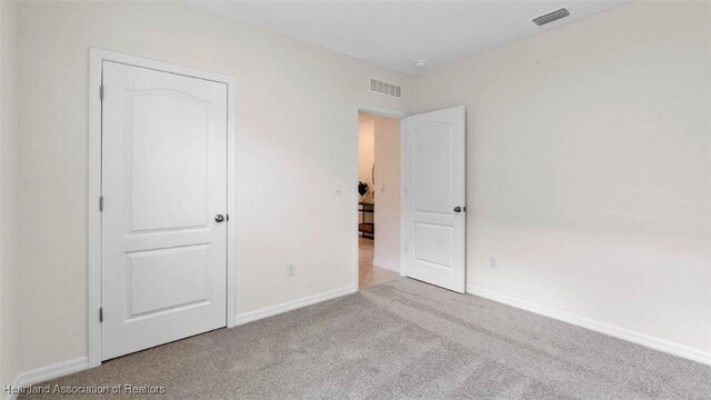 6824 Coconut Dr, Sebring, FL 33782 - unfurnished bedroom featuring carpet floors and baseboards