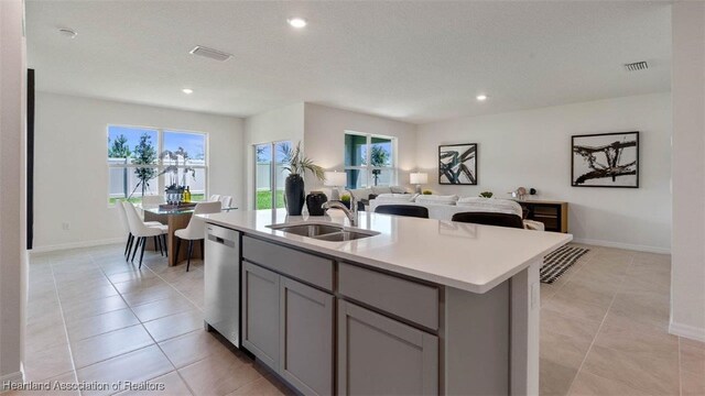 6824 Coconut Dr, Sebring, FL 33782 - kitchen featuring a sink, stainless steel dishwasher, gray cabinets, open floor plan, and light countertops