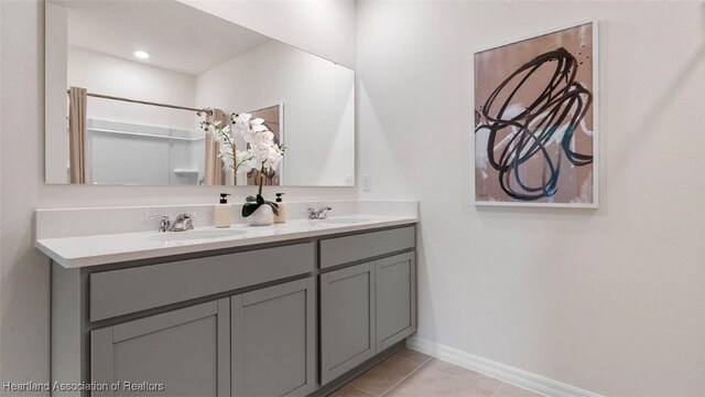 6824 Coconut Dr, Sebring, FL 33782 - bathroom with double vanity, tile patterned floors, baseboards, and curtained shower