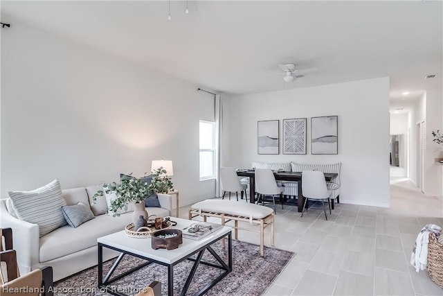 living room featuring visible vents and a ceiling fan