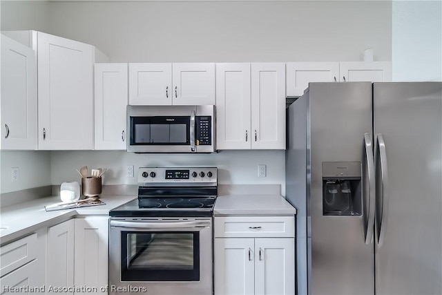 kitchen featuring white cabinetry, light countertops, and stainless steel appliances