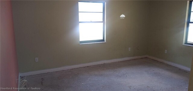 spare room with baseboards