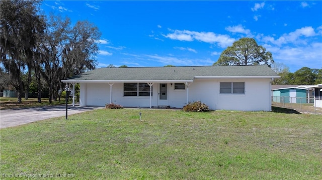 ranch-style house with a garage, driveway, a front lawn, and fence