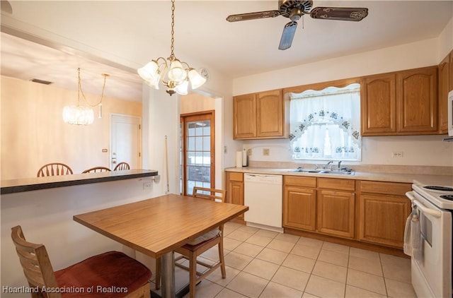 kitchen with a sink, visible vents, white appliances, and plenty of natural light