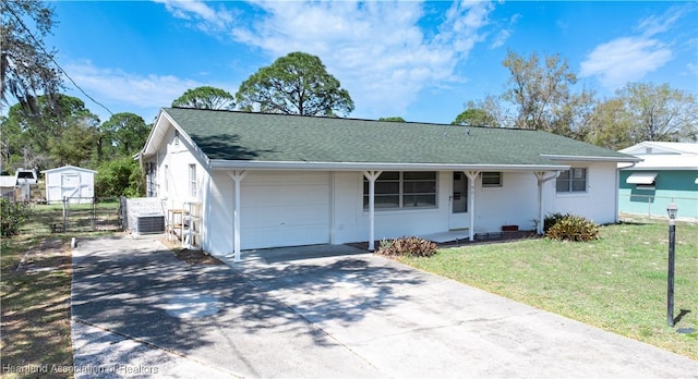 view of front of property with a front yard, an attached garage, fence, and concrete driveway