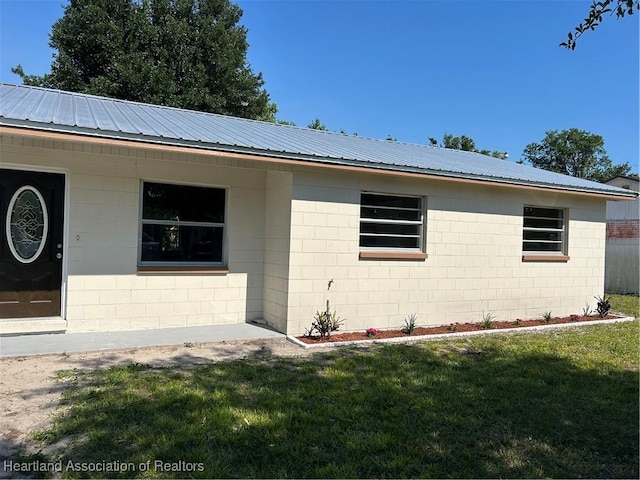 view of side of home featuring a yard