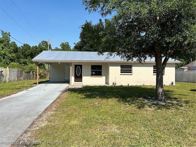 ranch-style home with a front yard and a carport