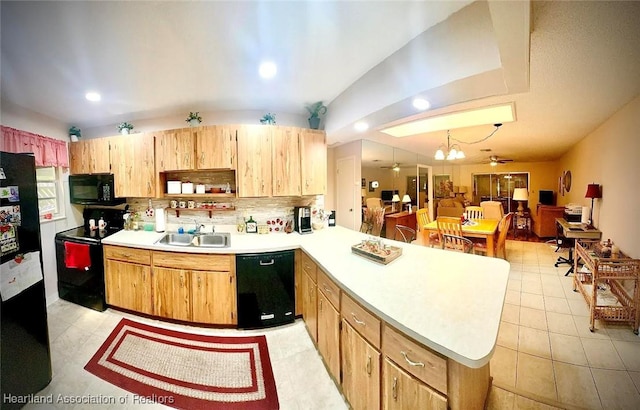 kitchen featuring black appliances, ceiling fan with notable chandelier, sink, hanging light fixtures, and kitchen peninsula