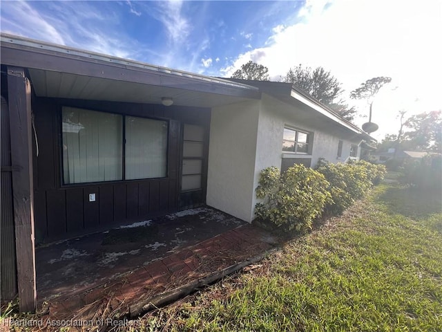 view of side of home with a yard