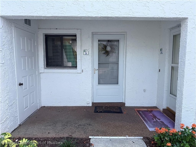 4701 Casablanca Cir Unit B5, Sebring, FL 33870 - entrance to property featuring visible vents and stucco siding