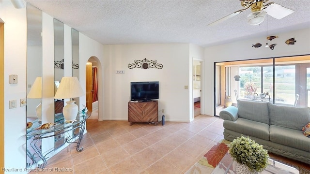 4701 Casablanca Cir Unit B5, Sebring, FL 33870 - living area featuring baseboards, a textured ceiling, a ceiling fan, light tile patterned flooring, and arched walkways