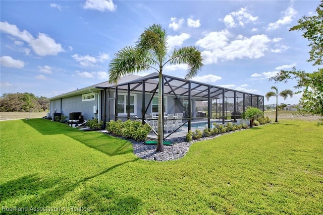 outdoor pool featuring a lanai, a yard, and central air condition unit