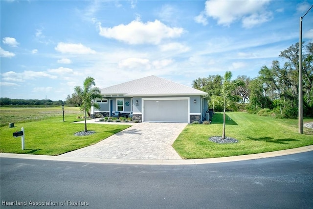 view of front of home with stucco siding, decorative driveway, a garage, stone siding, and a front yard