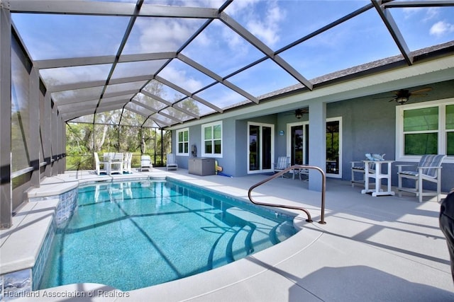 pool featuring a patio, a ceiling fan, and a lanai