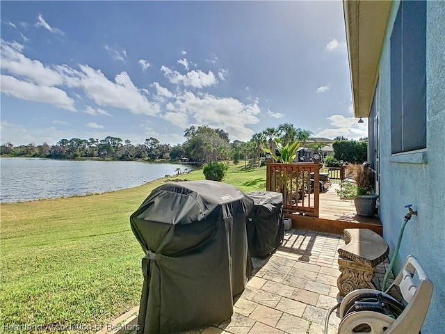 view of patio featuring area for grilling and a deck with water view