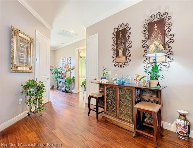 hall featuring wood-type flooring and ornamental molding