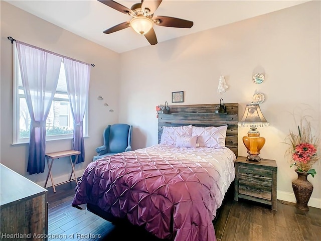 bedroom with ceiling fan and dark hardwood / wood-style floors