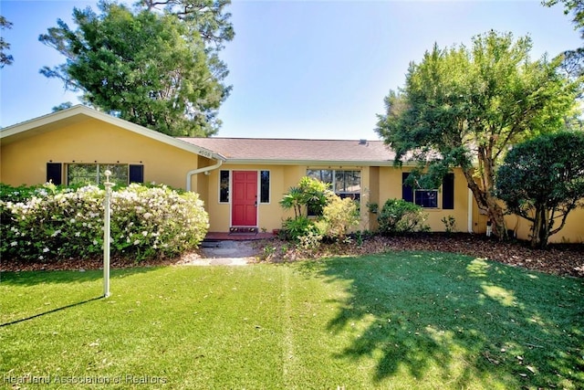 single story home featuring stucco siding and a front lawn