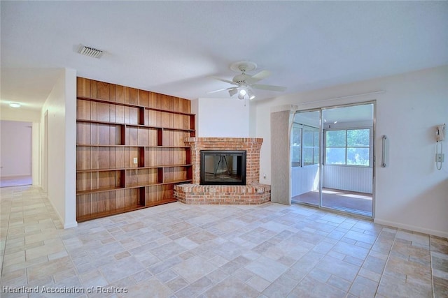 unfurnished living room with visible vents, baseboards, ceiling fan, built in features, and a fireplace